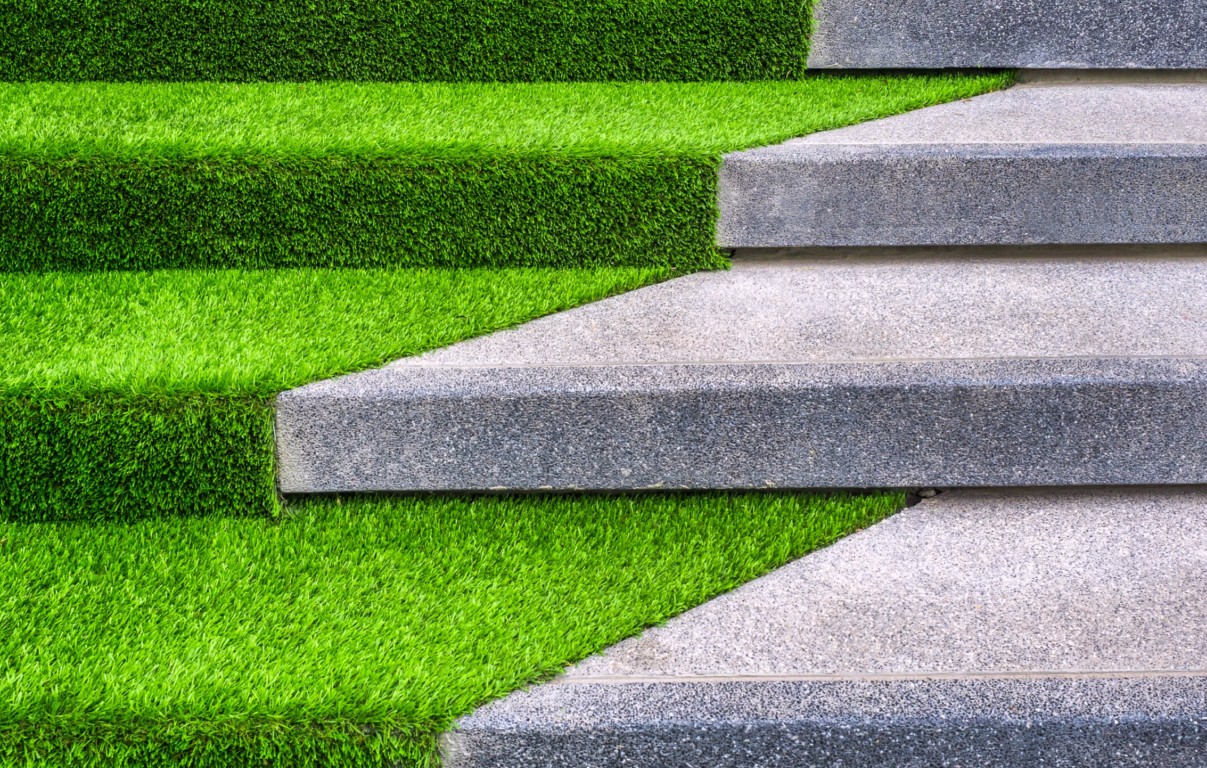 Paver and artificial turf installation combining hardscape with synthetic grass